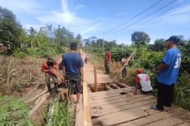 Satgas Pamtas bersama warga perbaiki jembatan di perbatasan Indonesia