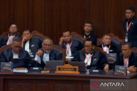 BW keluar dari ruang sidang MK saat Eddy Hiariej akan memberi paparan