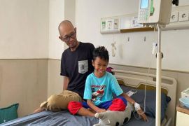 Program JKN membuat murid SD di Muara Teweh ini senyum sumringah