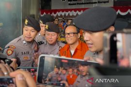 Wamenaker Immanuel Ebenezer menangis dan tersenyum usai menjadi tersangka