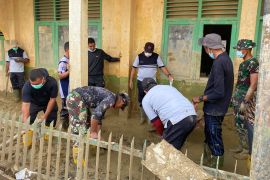 Prajurit TNI AD dan relawan bersihkan fasilitas  SMA Al-Jamiatul Washliyah Aceh Tamiang