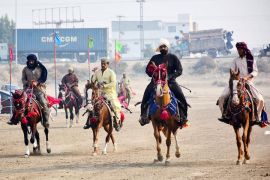 Aksi penunggang kuda berkompetisi dalam lomba pacuan kuda di Pakistan
