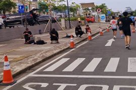 Fotografer orang lari di CPI Makassar, penghasilan tergantung cuaca
