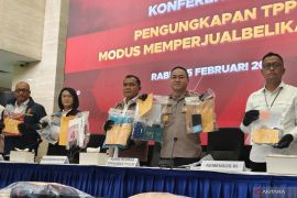 Indonesian police name 12 suspects in baby trafficking case
