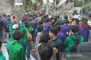 Mahasiswa mencoba terobos blokade dengan menarik pagar beton