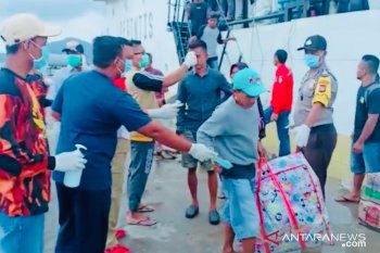 Penumpang di  Pelabuhan Tambelan mendapat disinpektan dan masker