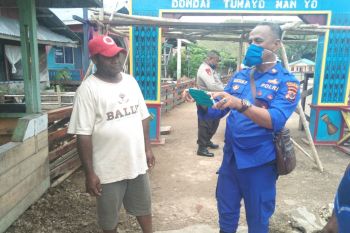 Polairud Jayapura bagi masker gratis kepada warga sekitar Danau Sentani