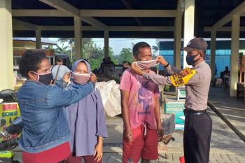 Lurah dan Bhabinkamtibmas Koya Timur bagikan masker gratis di pasar