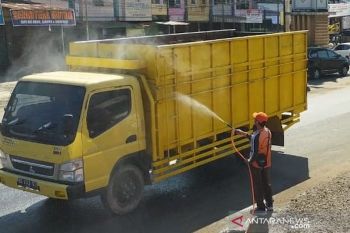 Setelah penetapan zona merah, sejumlah truk lintasi jalan utama Kabupaten Banyuasin disemprot cairan disinfektan