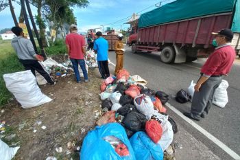 Sampah berbau busuk berserakan di Jalan Raya Bukittinggi-Payakumbuh, warga inisiatif lakukan pembersihan
