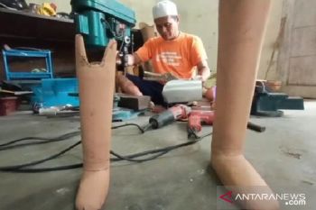 Syahroni membuat kaki palsu agar penyandang disabilitas bisa tersenyum