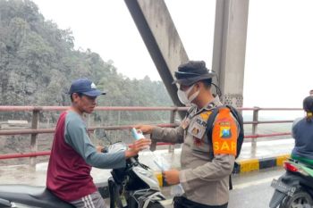 Mount Semeru eruption: Police hand out masks as ash covers key route