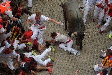 Seorang pria ditanduk saat balap lari dengan banteng di Pamplona