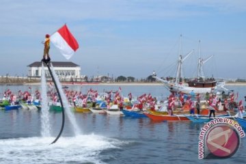 PENGIBARAN BENDERA PANTAI LOSARI