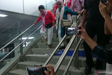 Ibu Negara merapikan stiker yang lepas di tangga MRT Jakarta