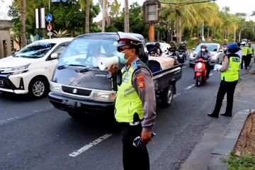 Petugas Polantas Bali bagikan masker kepada pengguna jalan
