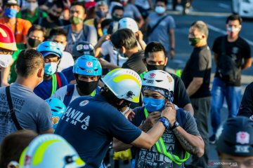 Pembagian helm gratis untuk pengendara sepeda di Manila