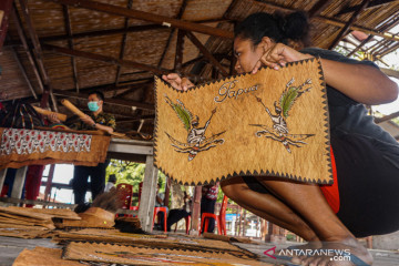 Suvenir PON Papua dari lukisan kulit kayu