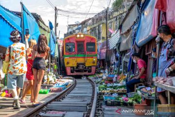 Pasar Rel Kereta Maeklong yang terkenal di Thailand