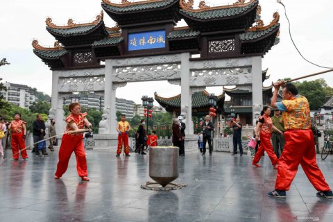 Atraksi memainkan gasing raksasa seberat 243 kilogram