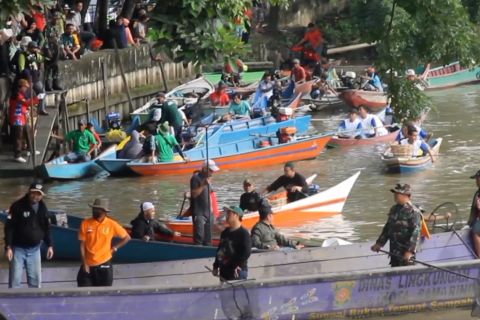 Aksi bersih sungai Karang Mumus dengan perahu ketinting