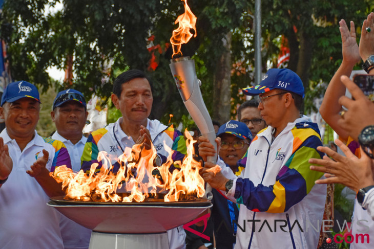 Asian Games - Senior minister Panjaitan takes part in Asian Games Torch relay
