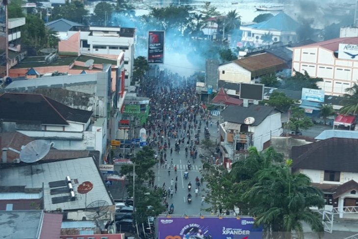 Security personnel fire tear gas to diffuse rioters in Papua
