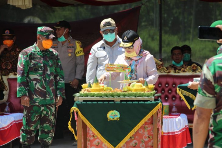 Foto - Anggota DPR Idah Syahidah potong tumpeng dimulainya pembangunan Kodim di Boalemo