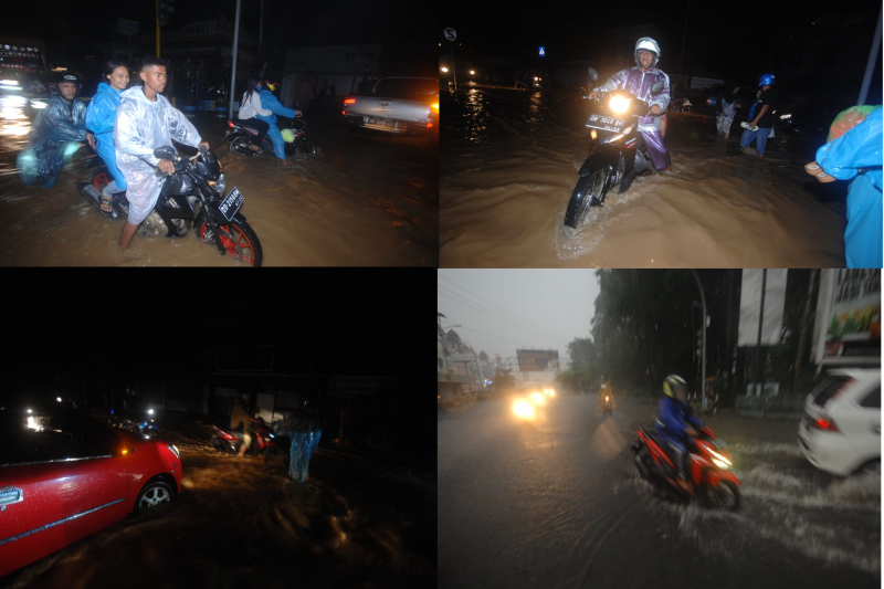 Pengendara menerobos banjir di jalan utama Kota Manado