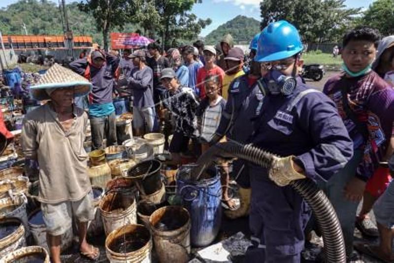 Warga Kumpulkan Tumpahan Minyak Di Cilacap